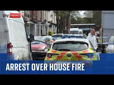 Woman held after two young children die in house fire